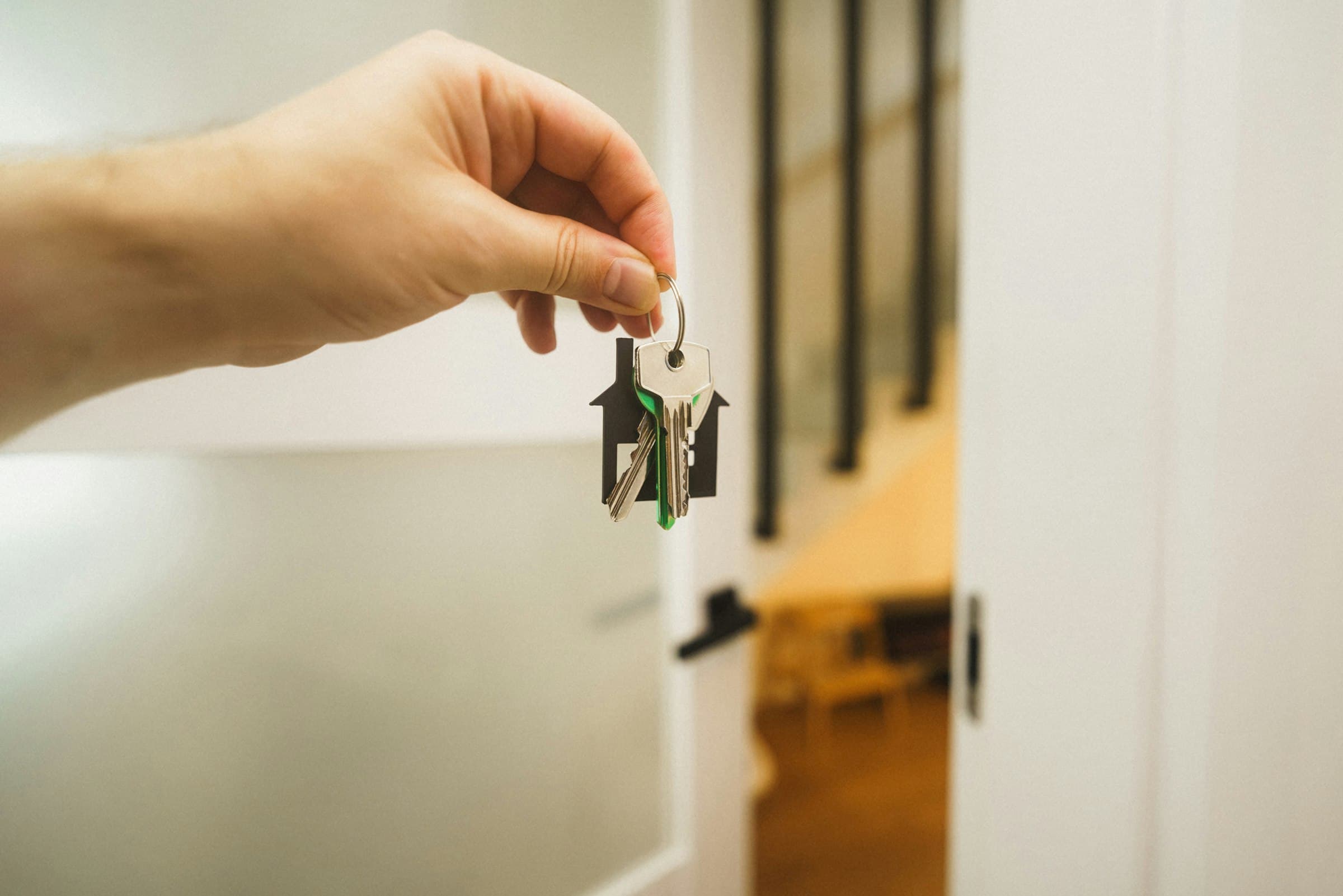 A hand holding the keys to a new home